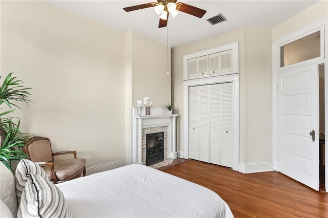 1203 Constantinople St Unit 1, New Orleans, LA 70115 - bedroom with wood finished floors, a fireplace with flush hearth, and ceiling fan