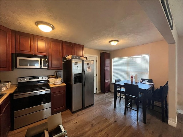 3204 Claire Ave, Gretna, LA 70053 - kitchen with appliances with stainless steel finishes, light countertops, a textured ceiling, and light wood-style floors
