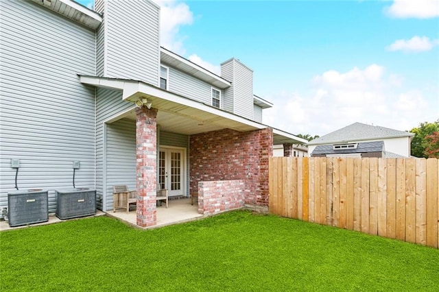 4339 Anthony St, Metairie, LA 70001 - rear view of house featuring french doors, a chimney, a patio area, and brick siding