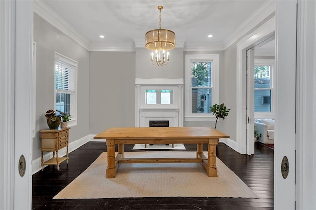 5349 Prytania St, New Orleans, LA 70115 - dining area with a chandelier, dark wood-style flooring, crown molding, a fireplace, and recessed lighting