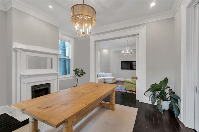 5349 Prytania St, New Orleans, LA 70115 - dining room featuring a chandelier, dark wood-style floors, a fireplace, recessed lighting, and crown molding