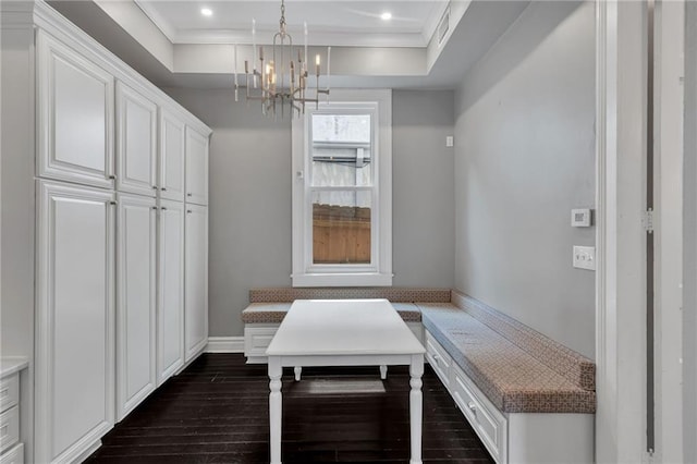 5349 Prytania St, New Orleans, LA 70115 - dining area featuring a chandelier, ornamental molding, dark wood finished floors, recessed lighting, and a raised ceiling