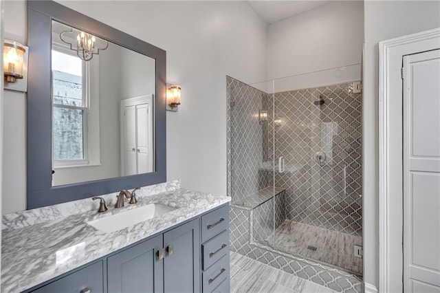 5349 Prytania St, New Orleans, LA 70115 - full bathroom featuring vanity, a shower stall, and a chandelier