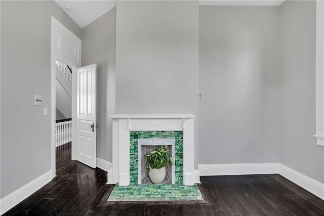 5349 Prytania St, New Orleans, LA 70115 - unfurnished living room with wood finished floors, a fireplace, and a towering ceiling