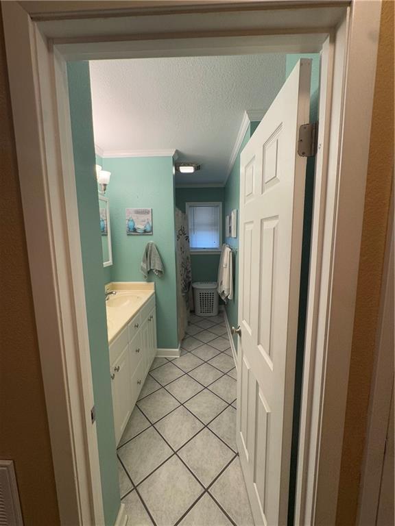 1620 Kent Ave, Metairie, LA 70001 - full bathroom featuring ornamental molding, vanity, and tile patterned flooring
