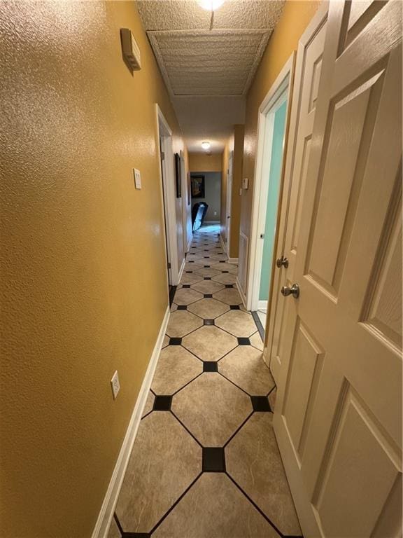 1620 Kent Ave, Metairie, LA 70001 - corridor featuring light tile patterned flooring and baseboards