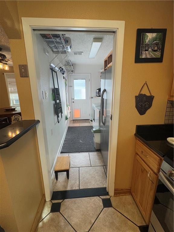 1620 Kent Ave, Metairie, LA 70001 - corridor with light tile patterned floors and a textured ceiling