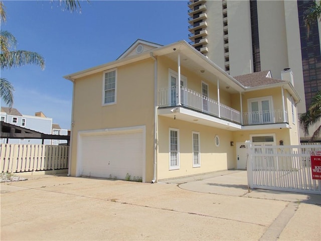 view of front of home featuring a balcony and a garage