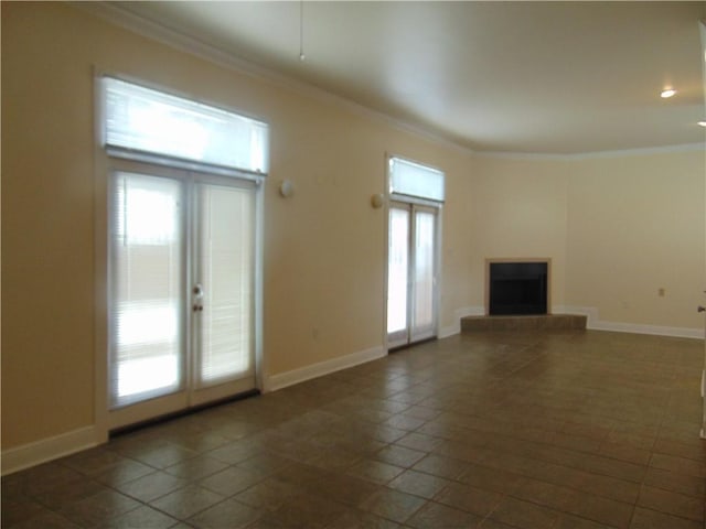 unfurnished living room with crown molding, french doors, and a wealth of natural light