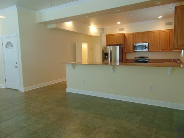 kitchen with sink, stainless steel appliances, ornamental molding, and dark tile flooring