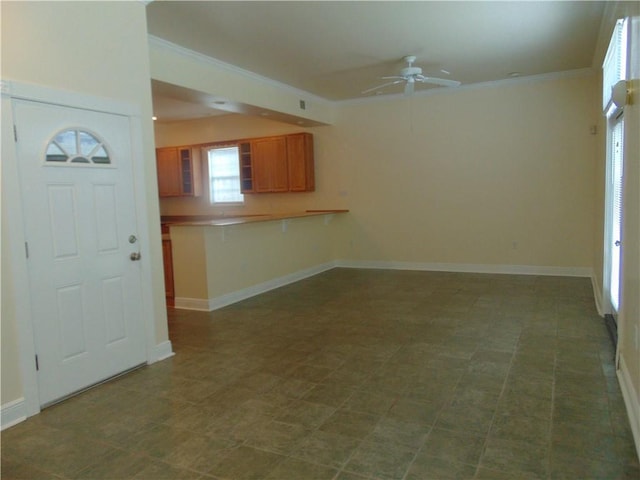 unfurnished living room with ceiling fan and dark tile flooring