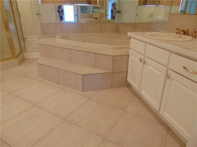 bathroom with plus walk in shower, tile floors, and oversized vanity