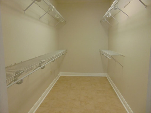 spacious closet featuring light tile floors