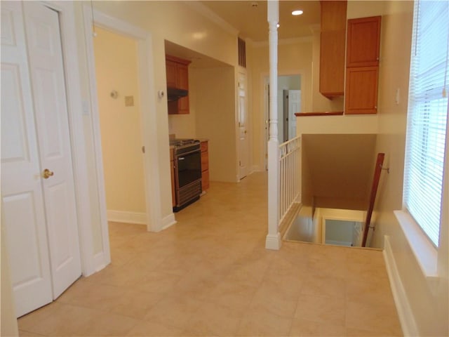 kitchen with range hood, stainless steel range with gas cooktop, and light tile flooring