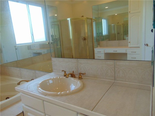 bathroom featuring backsplash, separate shower and tub, and vanity