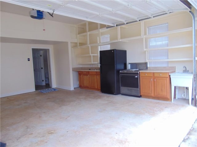 garage with a garage door opener and black refrigerator