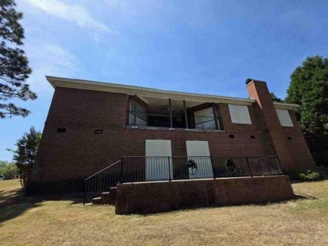 315 Bentwood Ln, Columbia, SC 29229 - rear view of house with brick siding, a chimney, and a yard