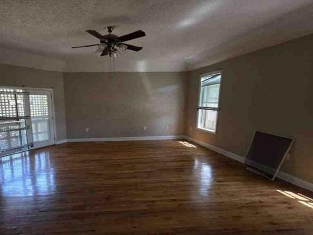 315 Bentwood Ln, Columbia, SC 29229 - unfurnished living room featuring baseboards, wood finished floors, a textured ceiling, and a ceiling fan