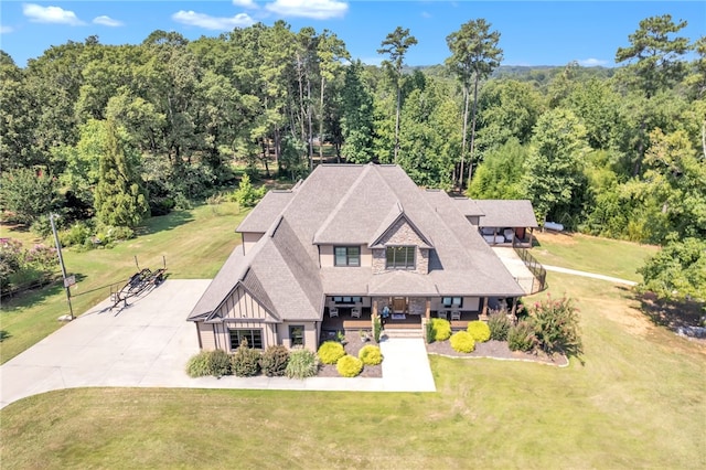 bird's eye view with a wooded view