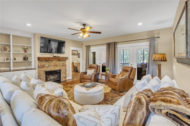 living room with french doors, a fireplace, a ceiling fan, and recessed lighting