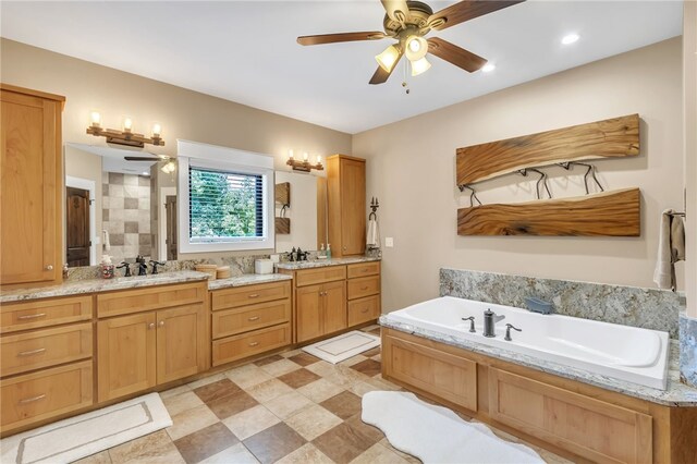 full bathroom with a ceiling fan, a sink, a bath, and double vanity