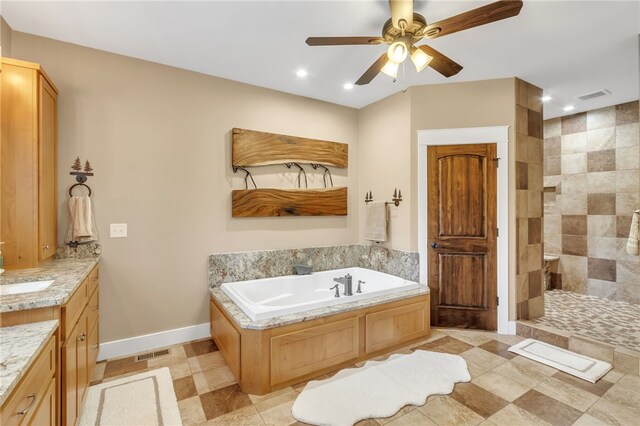 bathroom featuring baseboards, visible vents, a garden tub, walk in shower, and vanity