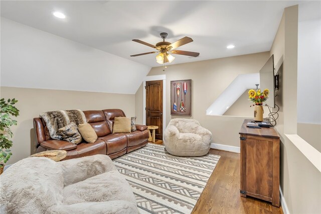 living area with baseboards, a ceiling fan, wood finished floors, vaulted ceiling, and recessed lighting