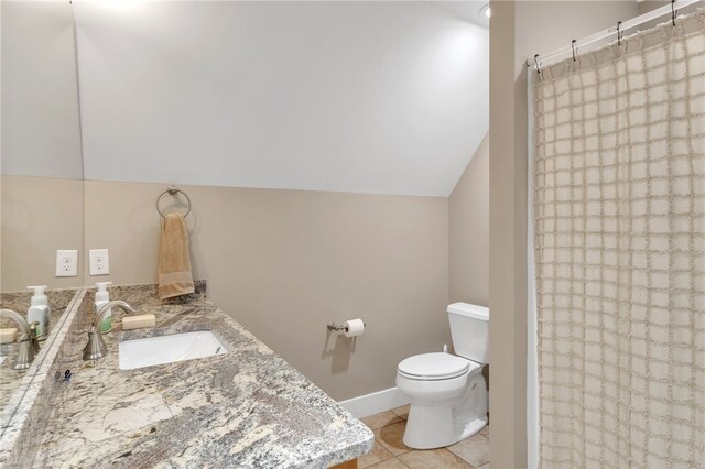 bathroom featuring curtained shower, lofted ceiling, toilet, vanity, and tile patterned flooring