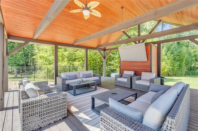 wooden terrace with ceiling fan, outdoor lounge area, and fence