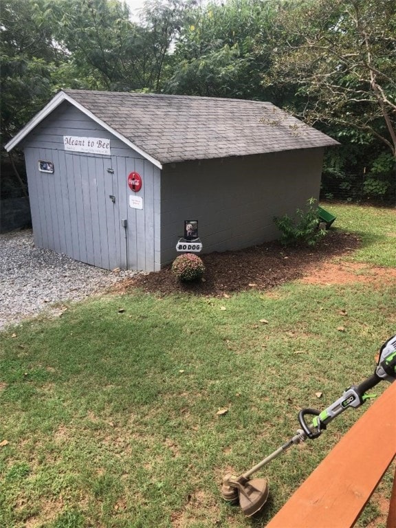 view of outdoor structure featuring a lawn