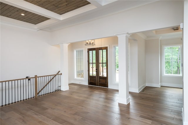 entrance foyer with beamed ceiling, dark hardwood / wood-style floors, wooden ceiling, a notable chandelier, and ornamental molding