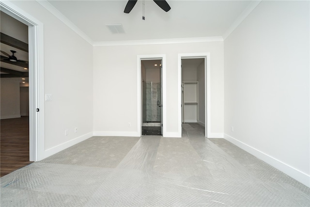 unfurnished bedroom with ensuite bathroom, ceiling fan, crown molding, light colored carpet, and a spacious closet