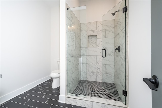 bathroom with tile patterned flooring, toilet, and an enclosed shower