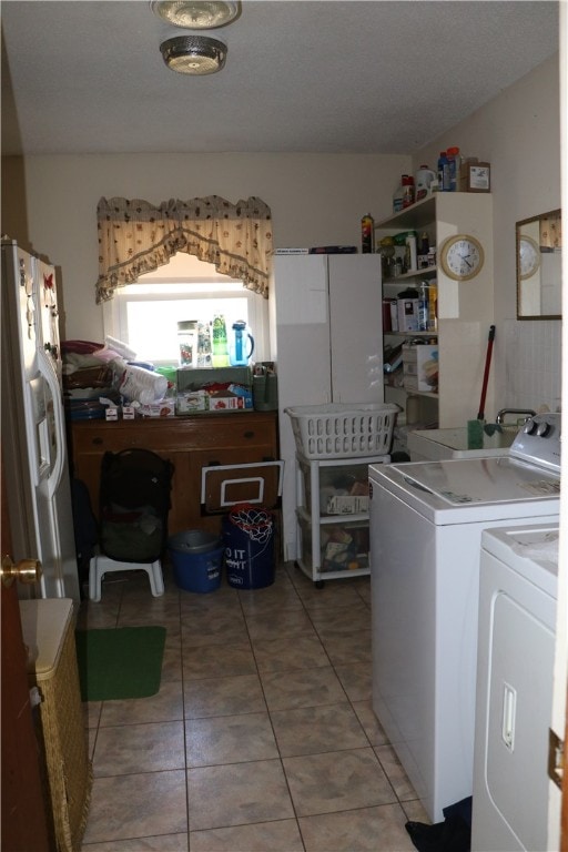 washroom with washer and clothes dryer and tile patterned floors