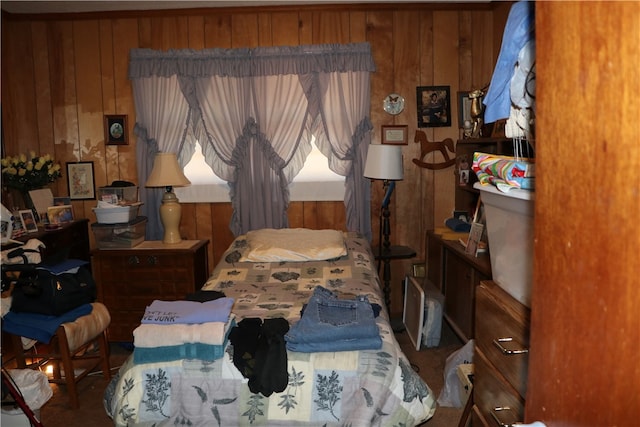 bedroom featuring wood walls