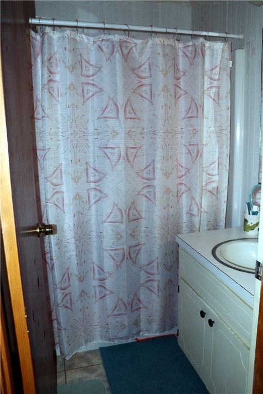 bathroom with vanity, tile patterned flooring, and curtained shower