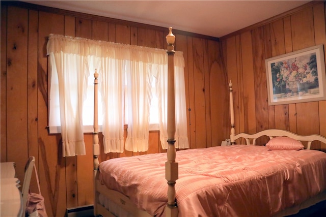 bedroom featuring crown molding and wood walls