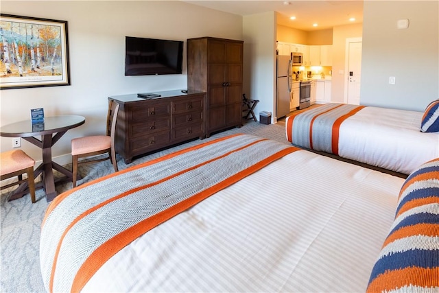 bedroom featuring light colored carpet, recessed lighting, and freestanding refrigerator
