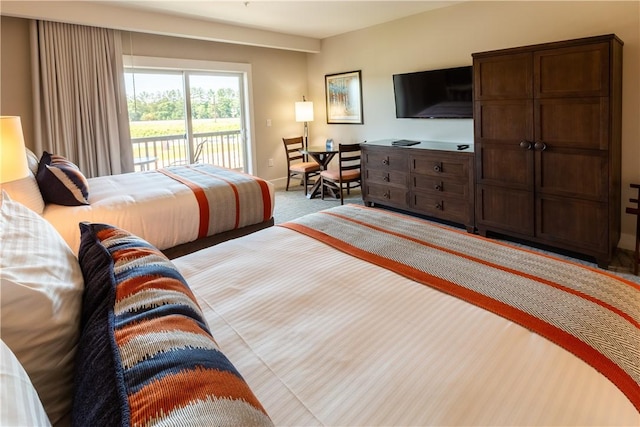 bedroom featuring carpet, baseboards, and access to outside