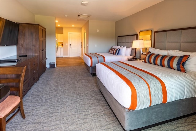 carpeted bedroom featuring visible vents