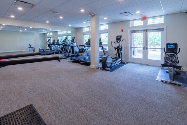 exercise room with french doors and a paneled ceiling