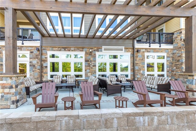 view of patio featuring a pergola, a balcony, and an outdoor hangout area