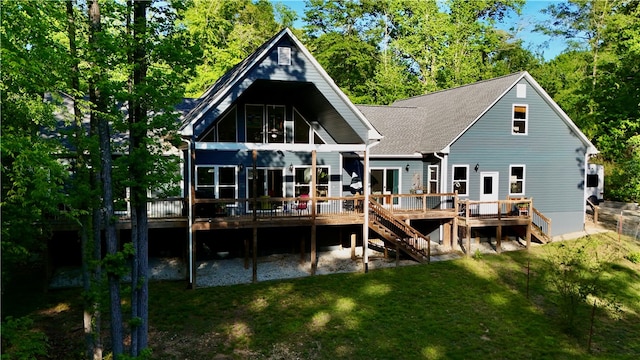 rear view of property with a wooden deck and a yard