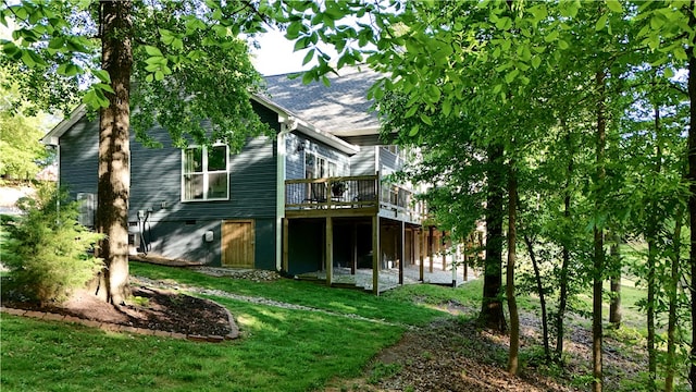 back of house featuring a yard and a wooden deck