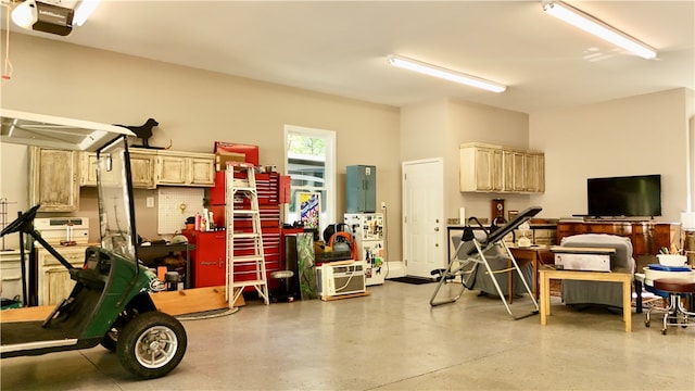 garage featuring a garage door opener and a workshop area