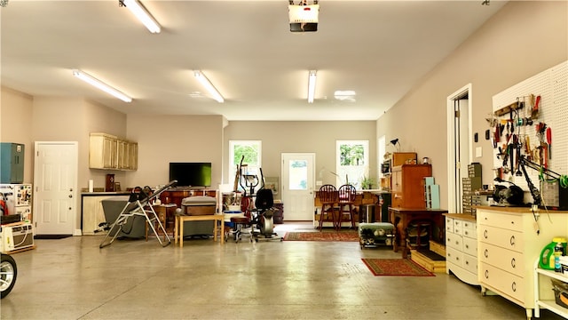 garage with a garage door opener and a workshop area