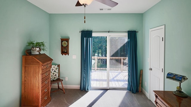 doorway to outside with ceiling fan, dark carpet, and a wealth of natural light