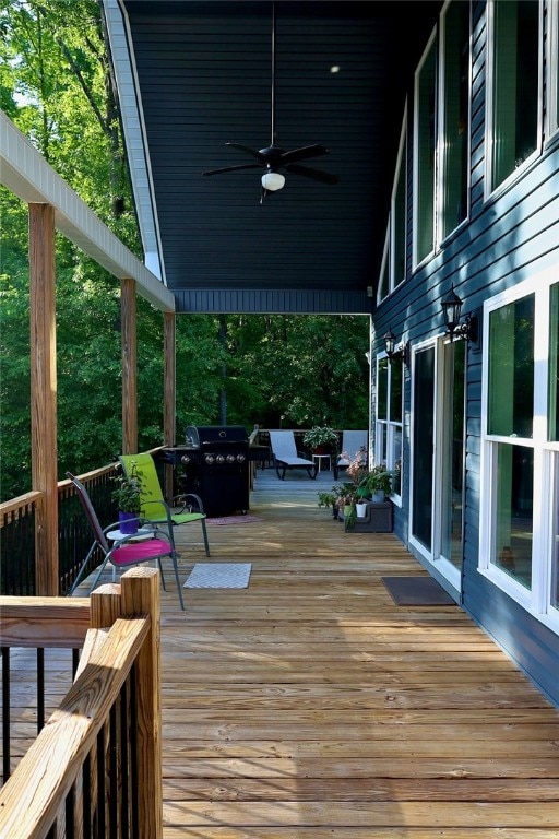 deck featuring ceiling fan and a grill