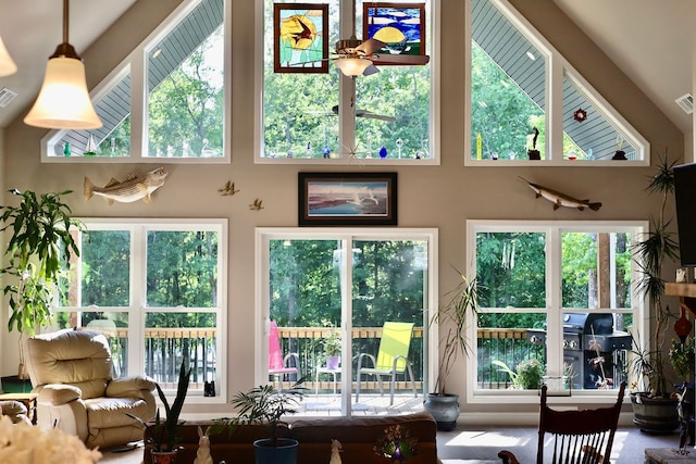 sunroom with vaulted ceiling and a healthy amount of sunlight