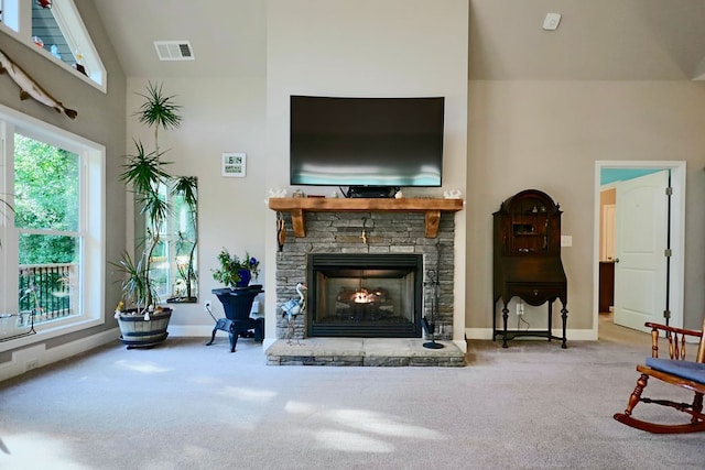 living room featuring carpet floors, a fireplace, and high vaulted ceiling